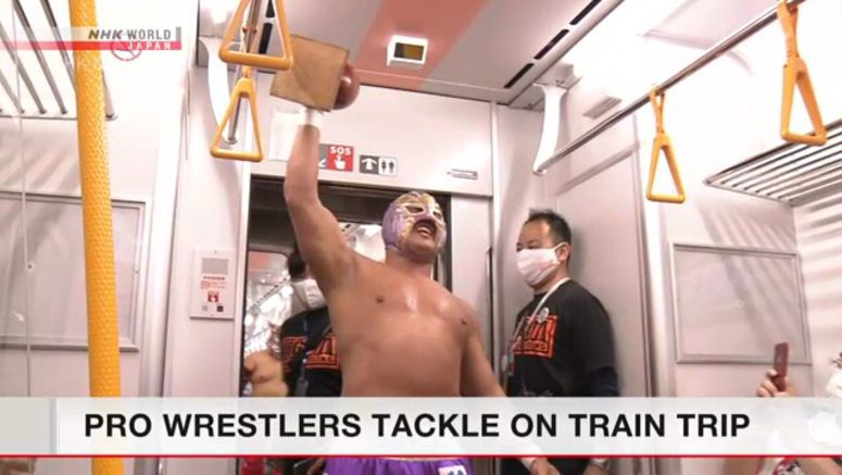 Pro wrestlers perform on a train