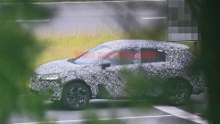 Nissan Rogue Sport spied covered in camo from atop a tree