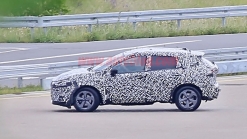 Nissan Rogue Sport spied covered in camo from atop a tree