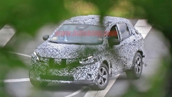 Nissan Rogue Sport spied covered in camo from atop a tree