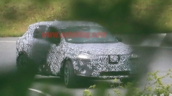 Nissan Rogue Sport spied covered in camo from atop a tree