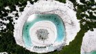 Melting snow creates gigantic 'dragon eye' on mountain