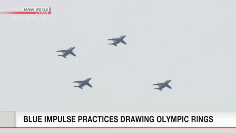 Aerobatic team practices drawing Olympic ring