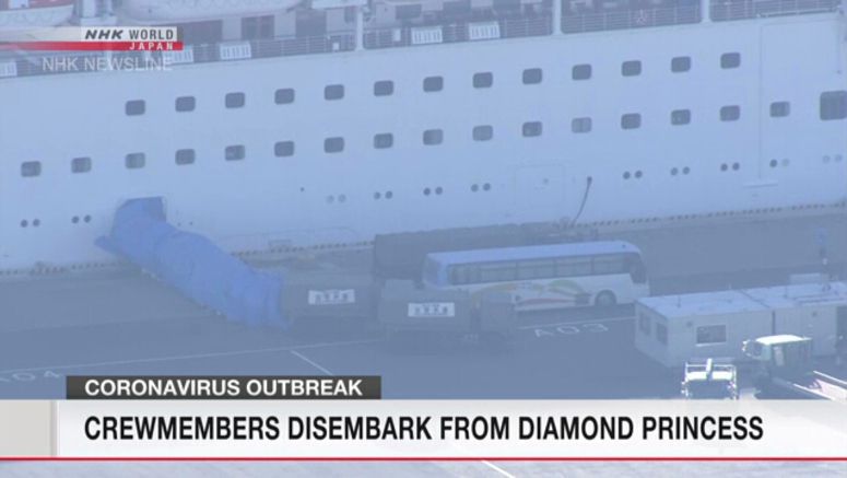 Crew members disembark from Diamond Princess