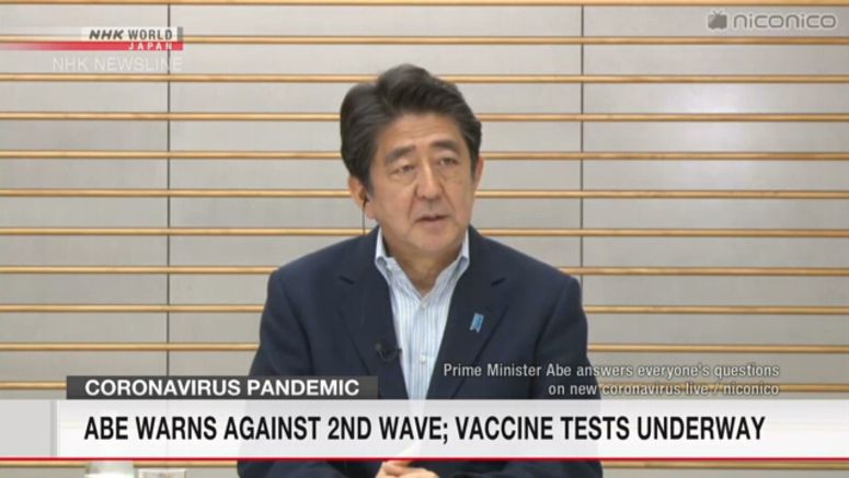 Abe warns against 2nd wave; vaccine tests underway