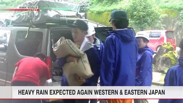 Rafting guides carry relief goods to Kuma people