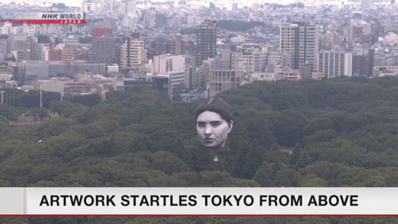 Giant balloon with human face floats over Tokyo