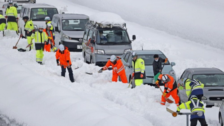 Giant traffic jam strands hundreds after snow storm in Japan